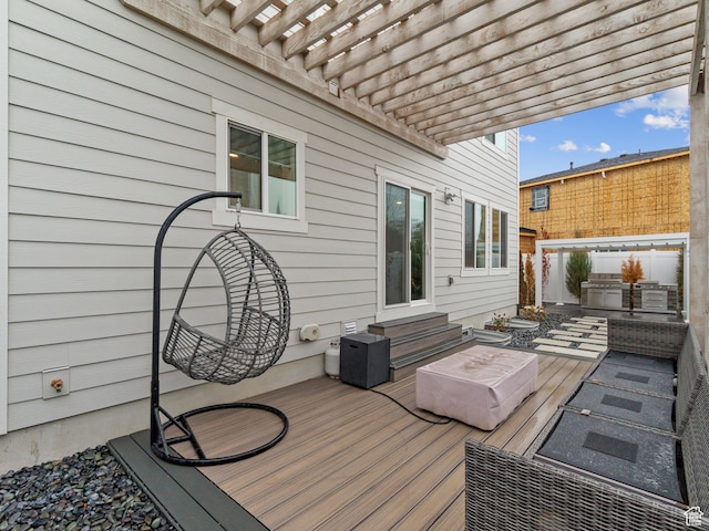 wooden deck with a pergola and area for grilling