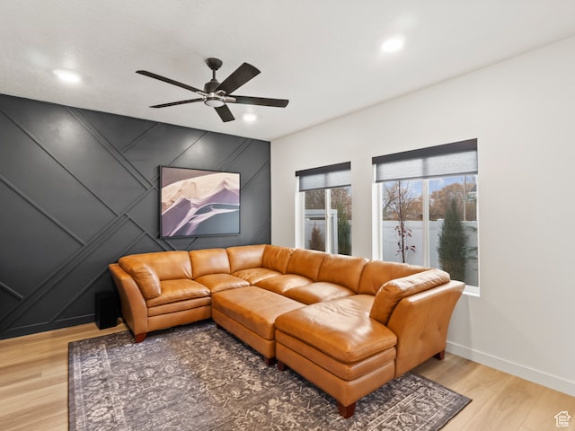living room with wood-type flooring and ceiling fan