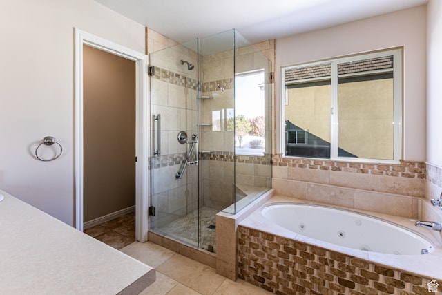 bathroom with tile patterned flooring and independent shower and bath