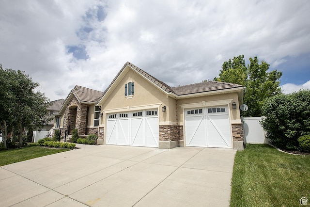 616 W 3200 N, Lehi, UT 84043 - view of front of property with stone siding, concrete driveway, stucco siding, a garage, and a tile roof