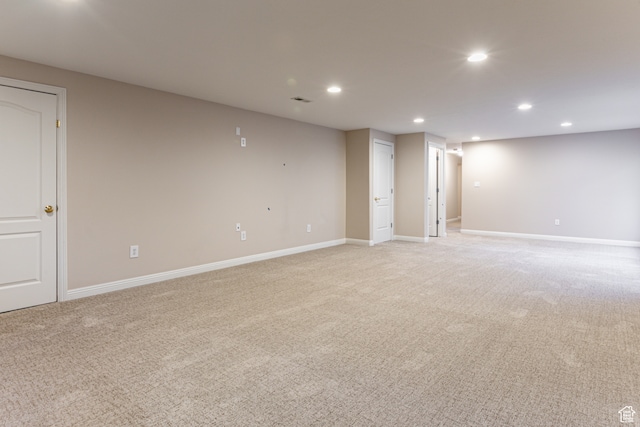 unfurnished room featuring light colored carpet