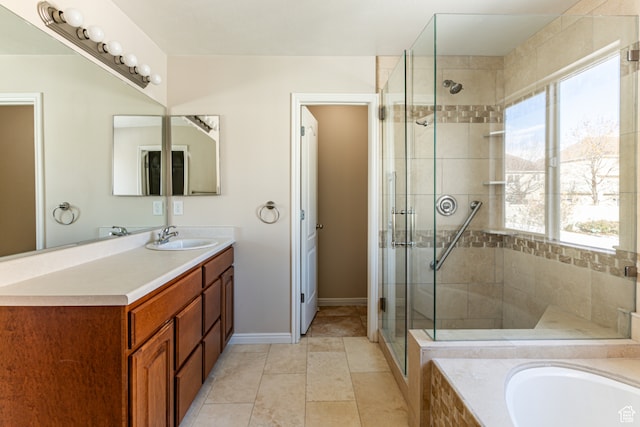 bathroom featuring tile patterned flooring, vanity, and plus walk in shower