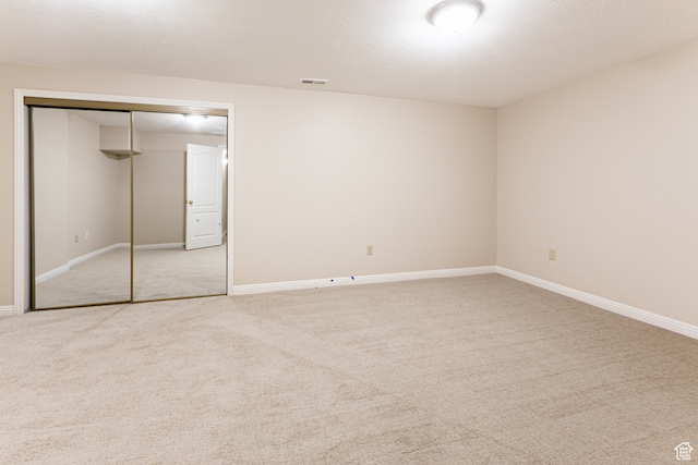 unfurnished bedroom featuring a closet and carpet floors