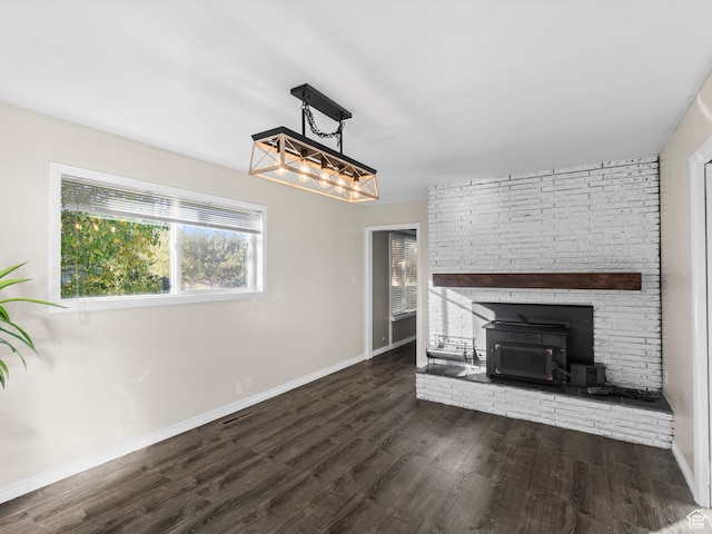 552 E 250 N, Bountiful, UT 84010 - unfurnished living room with a wood stove and dark wood-type flooring