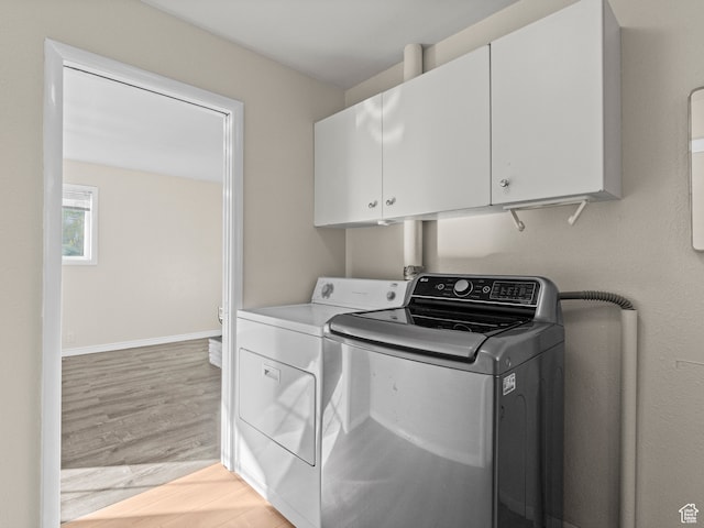 552 E 250 N, Bountiful, UT 84010 - laundry room with cabinets, light wood-type flooring, and washing machine and dryer