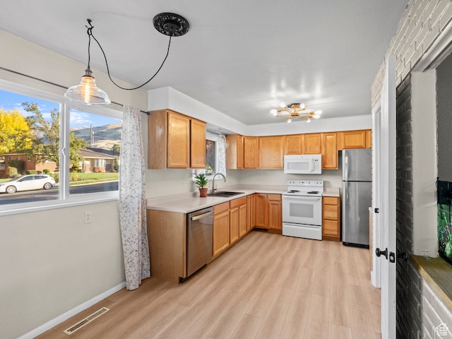 552 E 250 N, Bountiful, UT 84010 - kitchen featuring pendant lighting, sink, light hardwood / wood-style floors, stainless steel appliances, and a chandelier