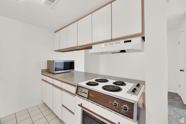31 N M St E Unit 308, Salt Lake City, UT 84103 - kitchen with white cabinetry, light tile patterned floors, and white cooktop