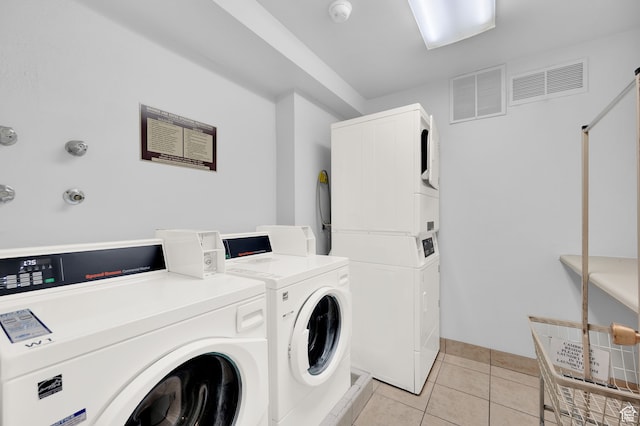 31 N M St E Unit 308, Salt Lake City, UT 84103 - clothes washing area with washer and clothes dryer, stacked washer / drying machine, and light tile patterned flooring