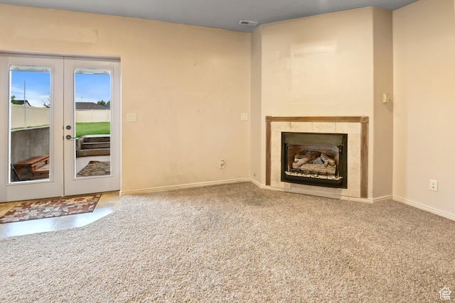545 N 1100 E, Beaver, UT 84713 - unfurnished living room featuring a tile fireplace, baseboards, carpet floors, and french doors
