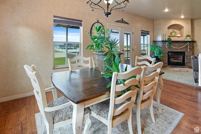 545 N 1100 E, Beaver, UT 84713 - dining space with wood finished floors, a chandelier, a fireplace, baseboards, and recessed lighting