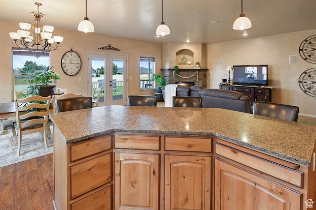 545 N 1100 E, Beaver, UT 84713 - kitchen with a chandelier, dark wood-style floors, french doors, stone countertops, and a brick fireplace