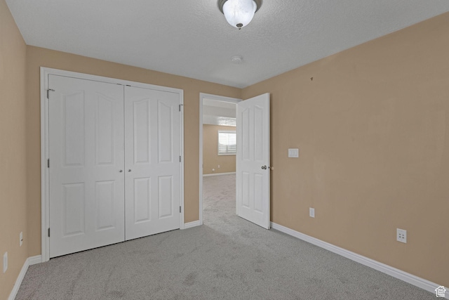 98 W 400 S, Smithfield, UT 84335 - unfurnished bedroom featuring baseboards, carpet, a closet, and a textured ceiling