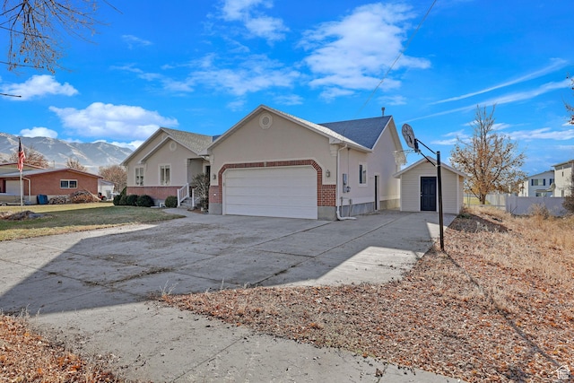 98 W 400 S, Smithfield, UT 84335 - view of front of property featuring a garage, a mountain view, driveway, and stucco siding