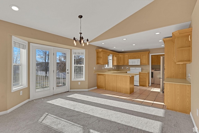 98 W 400 S, Smithfield, UT 84335 - kitchen featuring white appliances, a peninsula, light countertops, vaulted ceiling, and baseboards