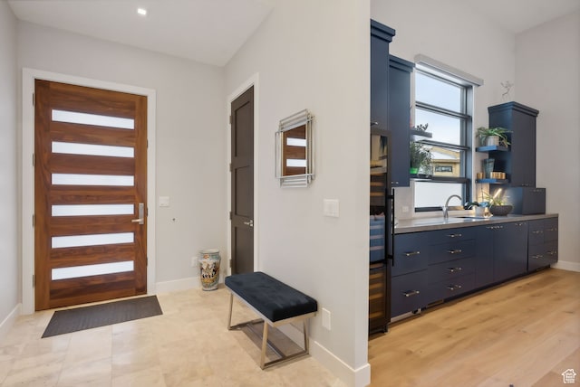 entryway featuring sink and light hardwood / wood-style flooring