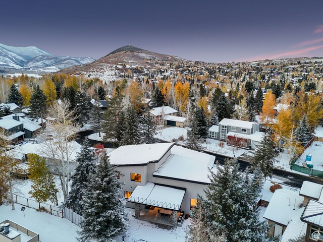 snowy aerial view with a mountain view