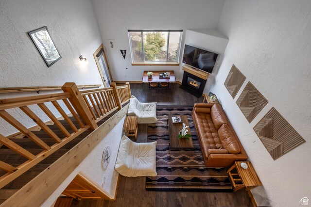 2653 W Canyons Resort Dr Unit 322, Park City, UT 84098 - living area with wood finished floors, a glass covered fireplace, a textured wall, and a skylight