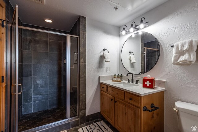 2653 W Canyons Resort Dr Unit 322, Park City, UT 84098 - full bath featuring a textured wall, vanity, a stall shower, and tile patterned flooring