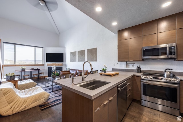 2653 W Canyons Resort Dr Unit 322, Park City, UT 84098 - kitchen featuring appliances with stainless steel finishes, open floor plan, a peninsula, dark wood-type flooring, and modern cabinets