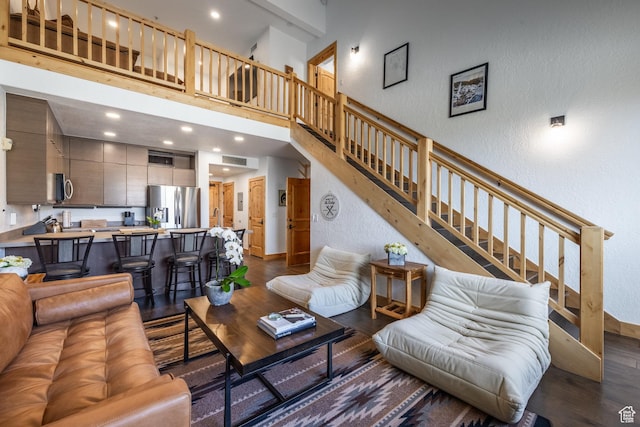 2653 W Canyons Resort Dr Unit 322, Park City, UT 84098 - living room featuring dark wood finished floors, stairs, a textured wall, recessed lighting, and a high ceiling