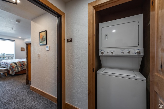 2653 W Canyons Resort Dr Unit 322, Park City, UT 84098 - laundry room featuring stacked washing machine and dryer, a textured wall, and carpet