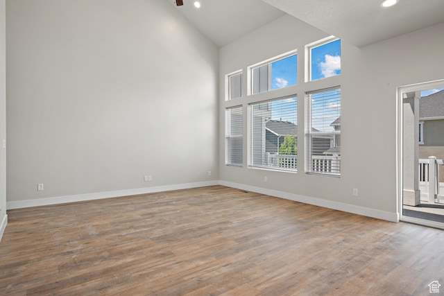 9781 N Aaron Ave Unit 207, Eagle Mountain, UT 84005 - empty room featuring wood finished floors, high vaulted ceiling, recessed lighting, and ceiling fan