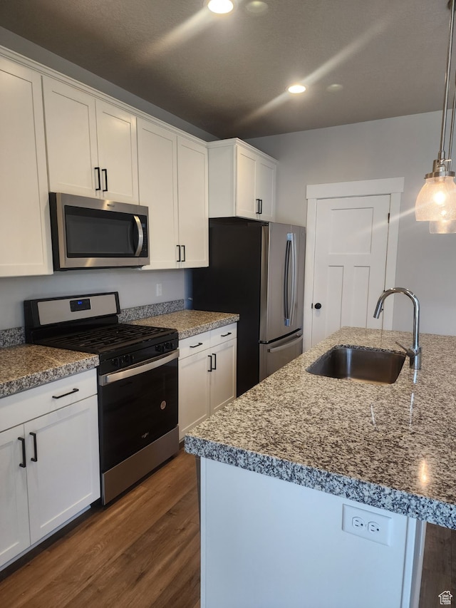 9781 N Aaron Ave Unit 207, Eagle Mountain, UT 84005 - kitchen featuring sink, white cabinets, hanging light fixtures, and appliances with stainless steel finishes