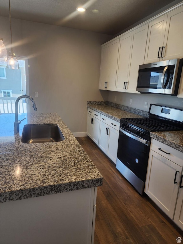 9781 N Aaron Ave Unit 207, Eagle Mountain, UT 84005 - kitchen with appliances with stainless steel finishes, a sink, recessed lighting, dark wood finished floors, and white cabinetry