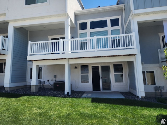 9781 N Aaron Ave Unit 207, Eagle Mountain, UT 84005 - rear view of property with central air condition unit, a patio area, a yard, and a balcony