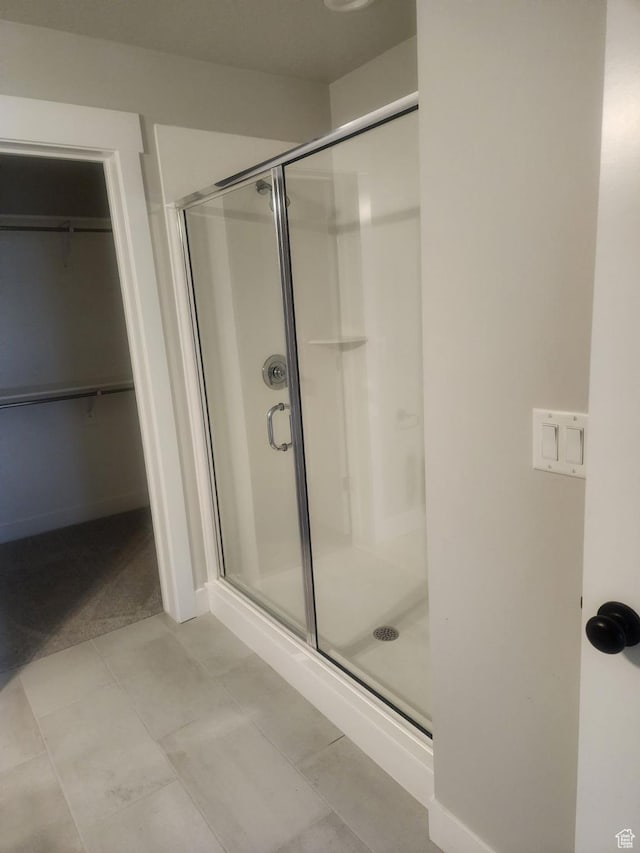 9781 N Aaron Ave Unit 207, Eagle Mountain, UT 84005 - full bathroom with a stall shower, a walk in closet, and tile patterned flooring