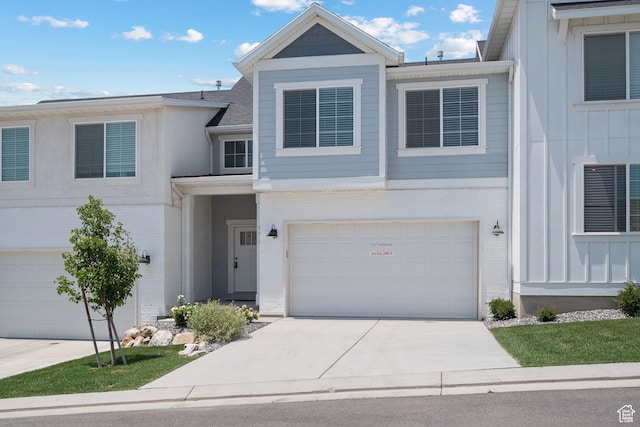 9781 N Aaron Ave Unit 207, Eagle Mountain, UT 84005 - multi unit property with brick siding, a garage, concrete driveway, and board and batten siding