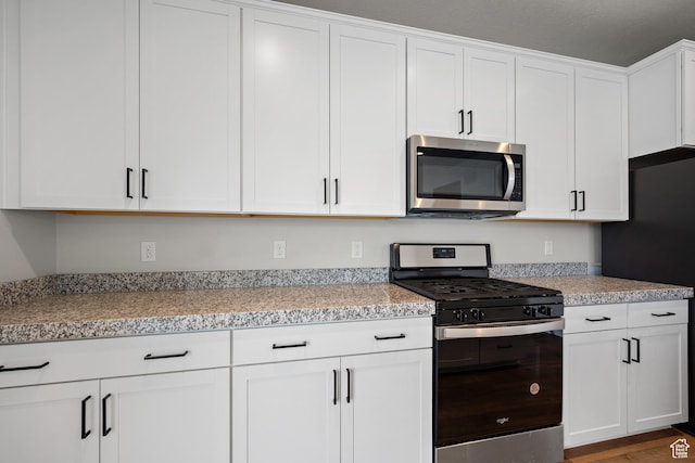 9781 N Aaron Ave Unit 207, Eagle Mountain, UT 84005 - kitchen featuring stainless steel appliances, white cabinets, and light countertops
