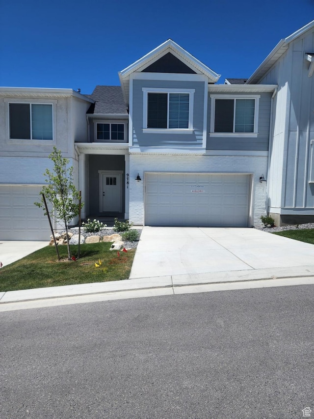 9781 N Aaron Ave Unit 207, Eagle Mountain, UT 84005 - view of front facade featuring a garage and concrete driveway