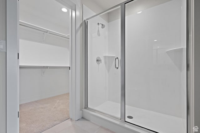 9781 N Aaron Ave Unit 207, Eagle Mountain, UT 84005 - bathroom with a shower stall, a walk in closet, and tile patterned flooring