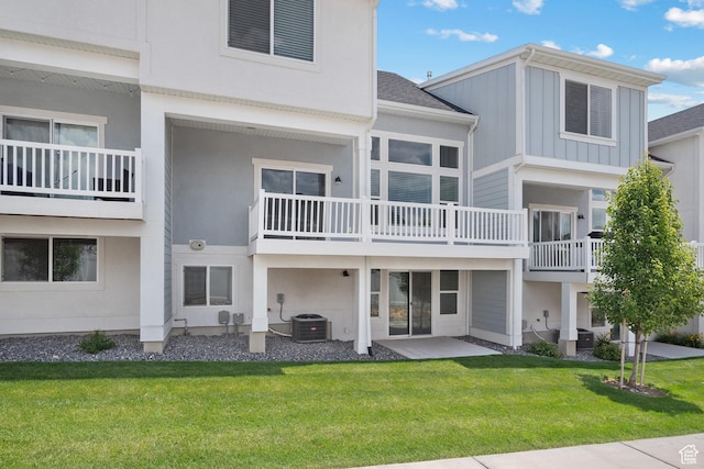 9781 N Aaron Ave Unit 207, Eagle Mountain, UT 84005 - rear view of property with a lawn, a patio, and board and batten siding