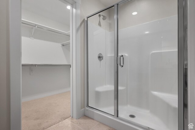 9807 N Aaron Ave Unit 210, Eagle Mountain, UT 84005 - bathroom with a stall shower, a spacious closet, tile patterned floors, and recessed lighting