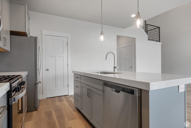 9807 N Aaron Ave Unit 210, Eagle Mountain, UT 84005 - kitchen featuring dishwasher, gray cabinets, light wood finished floors, gas stove, and light countertops