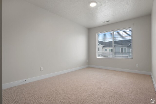 9807 N Aaron Ave Unit 210, Eagle Mountain, UT 84005 - spare room featuring light colored carpet and a textured ceiling