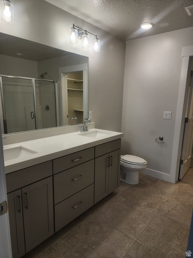 9807 N Aaron Ave Unit 210, Eagle Mountain, UT 84005 - bathroom with vanity, toilet, an enclosed shower, and a textured ceiling