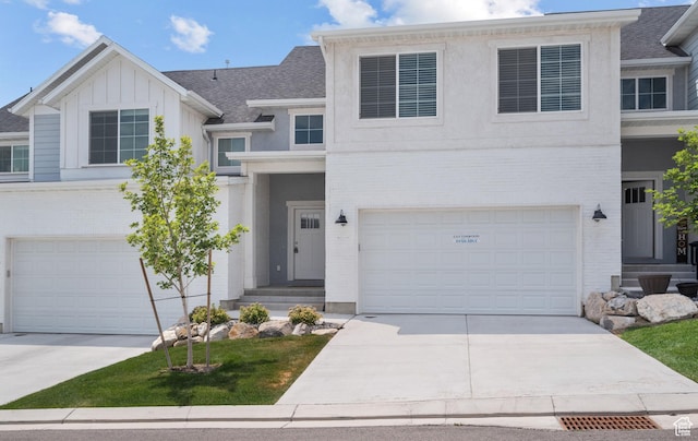 9807 N Aaron Ave Unit 210, Eagle Mountain, UT 84005 - view of front of home featuring driveway, a garage, and brick siding