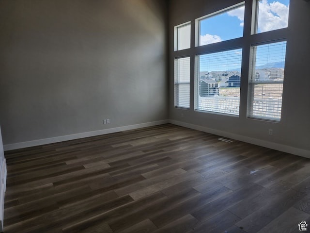 9807 N Aaron Ave Unit 210, Eagle Mountain, UT 84005 - unfurnished room with a towering ceiling and dark hardwood / wood-style flooring