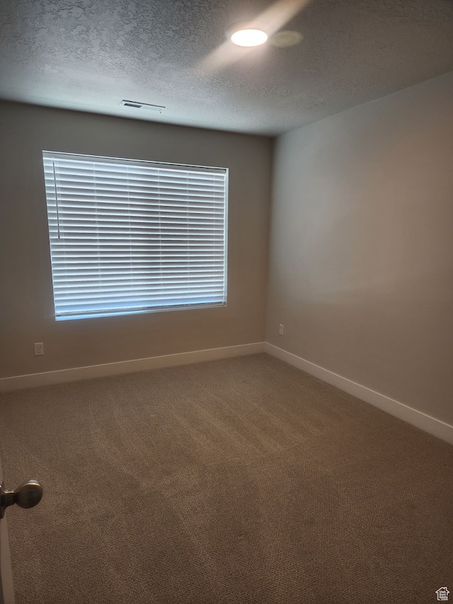 9807 N Aaron Ave Unit 210, Eagle Mountain, UT 84005 - carpeted empty room with a textured ceiling