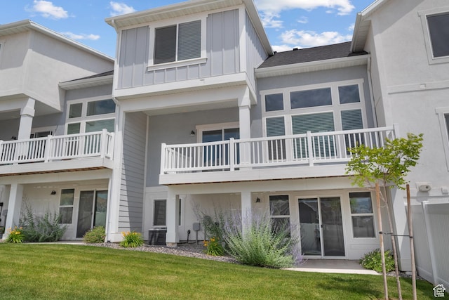 9807 N Aaron Ave Unit 210, Eagle Mountain, UT 84005 - rear view of property with board and batten siding and a yard