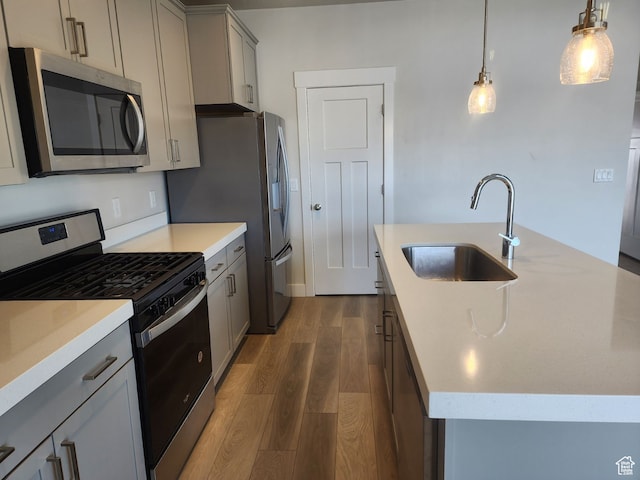 9807 N Aaron Ave Unit 210, Eagle Mountain, UT 84005 - kitchen with pendant lighting, sink, gray cabinets, appliances with stainless steel finishes, and dark hardwood / wood-style flooring
