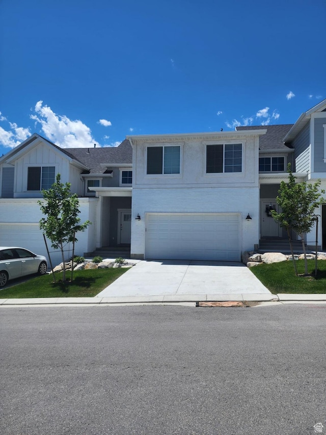 9807 N Aaron Ave Unit 210, Eagle Mountain, UT 84005 - view of front facade with a garage, driveway, and stucco siding