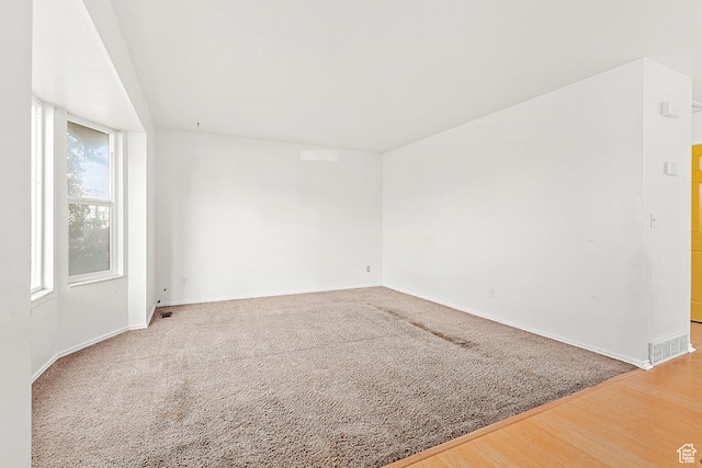 empty room with hardwood / wood-style floors
