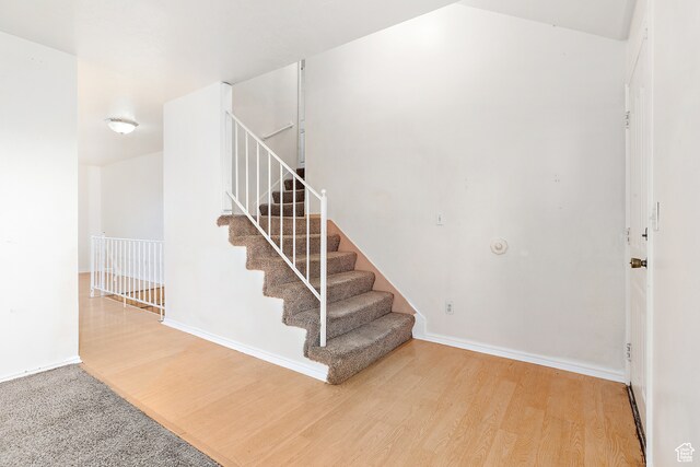 stairs with wood-type flooring
