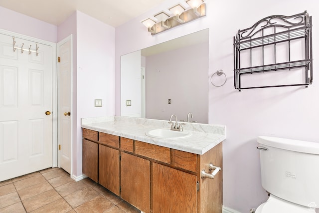 bathroom with tile patterned floors, vanity, and toilet