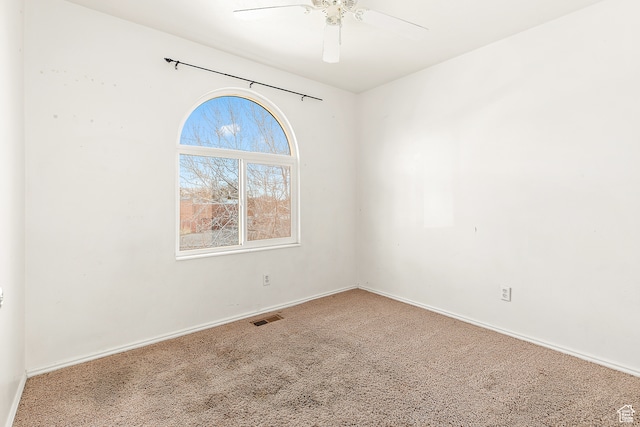 empty room featuring carpet and ceiling fan