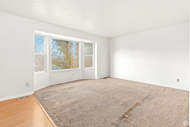 spare room with hardwood / wood-style flooring